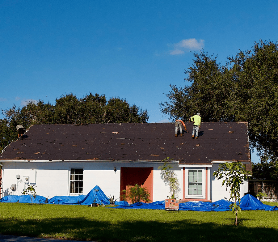 Roof tear-off and new shingle installation in progress by the Sunny Roofing crew