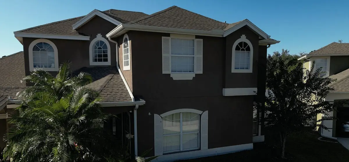 Two-story Orlando home with a new architectural shingle roof installed by Sunny Roofing